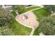 Aerial view of a community playground with mature trees and green lawns at 1911 E Hartford Ave, Phoenix, AZ 85022