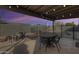 Backyard patio featuring outdoor seating, a round table, and a view of the fenced-in pool area at 19236 N 22Nd Ln, Phoenix, AZ 85027