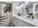 Updated bathroom with double vanity, modern mirrors, and stylish shower curtain at 19236 N 22Nd Ln, Phoenix, AZ 85027