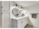 Bathroom with a double vanity, modern fixtures, and stylish round mirrors enhancing the space at 19236 N 22Nd Ln, Phoenix, AZ 85027