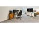 Carpeted bedroom featuring an office space, television on a dresser, and bright natural light at 19236 N 22Nd Ln, Phoenix, AZ 85027