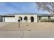 Charming home featuring an arched entryway, a two-car garage and desert landscaping at 19236 N 22Nd Ln, Phoenix, AZ 85027