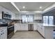 Bright kitchen featuring stainless steel appliances, white cabinets and quartz countertops at 19236 N 22Nd Ln, Phoenix, AZ 85027