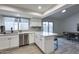 Bright kitchen featuring white cabinets, stainless appliances, and wood-look tile flooring at 19236 N 22Nd Ln, Phoenix, AZ 85027