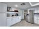 Updated kitchen area with stainless appliances, subway tile backsplash, and white cabinets with dark hardware at 19236 N 22Nd Ln, Phoenix, AZ 85027