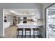 Modern kitchen with stainless steel appliances, white cabinets, a breakfast bar, and quartz countertops at 19236 N 22Nd Ln, Phoenix, AZ 85027