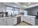 Bright kitchen featuring white cabinets, stainless appliances, and wood-look tile flooring at 19236 N 22Nd Ln, Phoenix, AZ 85027