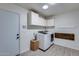 Laundry room featuring washer and dryer, and white cabinets for convenient storage at 19236 N 22Nd Ln, Phoenix, AZ 85027