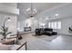 Spacious living room with vaulted ceiling, tile floors, and a modern chandelier at 19236 N 22Nd Ln, Phoenix, AZ 85027