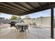 Covered patio features outdoor dining area with BBQ, dining table and chairs, and backyard landscaping at 19236 N 22Nd Ln, Phoenix, AZ 85027