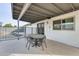 Covered patio with dining area and view of fenced-in pool, adjacent to the bright, windowed home exterior at 19236 N 22Nd Ln, Phoenix, AZ 85027