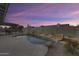 Inviting backyard pool featuring rock waterfall, desert landscaping, and spacious concrete surround at 19236 N 22Nd Ln, Phoenix, AZ 85027