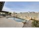 Inviting backyard pool featuring rock waterfall, desert landscaping, and spacious concrete surround at 19236 N 22Nd Ln, Phoenix, AZ 85027