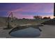 Backyard pool view with a dramatic dusk sky, rock features, and privacy wall at 19236 N 22Nd Ln, Phoenix, AZ 85027