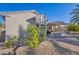 View of backyard with covered patio, xeriscaping, and mature desert plants at 19460 N Hidden Canyon Dr, Surprise, AZ 85374