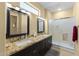 Spacious bathroom with double sinks, granite countertop, and glass shower at 19460 N Hidden Canyon Dr, Surprise, AZ 85374