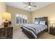 Cozy bedroom featuring a ceiling fan, shuttered windows, and a comfortable bed at 19460 N Hidden Canyon Dr, Surprise, AZ 85374