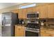 Updated kitchen features stainless steel appliances and granite countertops, as well as wooden cabinets at 19460 N Hidden Canyon Dr, Surprise, AZ 85374