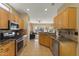 Bright kitchen features stainless steel appliances, granite countertops, and a view into the living area at 19460 N Hidden Canyon Dr, Surprise, AZ 85374