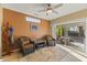 Inviting sun room with wicker chairs, ceiling fan, and sliding glass doors leading to the backyard at 19460 N Hidden Canyon Dr, Surprise, AZ 85374