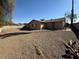 Wide shot of the gravel backyard. The house has a covered patio at 1954 W Kerry Ln, Phoenix, AZ 85027