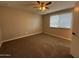 Bedroom with a large window, fan, neutral walls, and carpeted floor at 1954 W Kerry Ln, Phoenix, AZ 85027