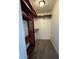 Closet with dark brown shelves, carpeted floor, and light at 1954 W Kerry Ln, Phoenix, AZ 85027