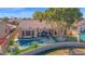 Aerial perspective showcasing a house, pool, and pond, creating a serene outdoor oasis at 2029 N 109Th Ave, Avondale, AZ 85392