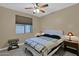 Cozy bedroom with ceiling fan, window, and coordinated nightstands and lamps at 2029 N 109Th Ave, Avondale, AZ 85392