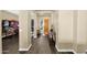 Elegant foyer with hardwood floors and a decorative table near the wooden front door at 2029 N 109Th Ave, Avondale, AZ 85392