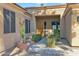 Inviting front entrance with a wooden door, gravel landscaping, and a potted plant at 2029 N 109Th Ave, Avondale, AZ 85392