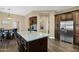 Kitchen island with granite countertops, stainless steel appliances, and dark wood cabinets at 2029 N 109Th Ave, Avondale, AZ 85392