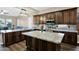 Modern kitchen with granite countertops, a central island, and stainless steel appliances at 2029 N 109Th Ave, Avondale, AZ 85392