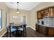 Dining table with dark wood cabinets and granite countertops at 2029 N 109Th Ave, Avondale, AZ 85392