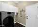 Laundry room with white cabinets and modern washer and dryer at 2029 N 109Th Ave, Avondale, AZ 85392