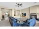 Cozy living room with fireplace, ceiling fan, and comfortable seating area at 2029 N 109Th Ave, Avondale, AZ 85392