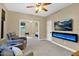 Open concept living room with fireplace feature and sitting area leading into the bedroom at 2029 N 109Th Ave, Avondale, AZ 85392