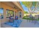 Covered patio features an outdoor seating area with ceiling fan and view of the artificial grass yard at 2029 N 109Th Ave, Avondale, AZ 85392