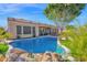 Backyard pool featuring rock waterfall with views of the lake and outdoor seating at 2029 N 109Th Ave, Avondale, AZ 85392