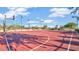 Outdoor basketball court with a red surface and white lines, perfect for sports and recreation at 2046 N Red Clf, Mesa, AZ 85207