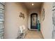 Inviting front entrance with a wrought iron door, bench seating, and stylish decor at 2046 N Red Clf, Mesa, AZ 85207