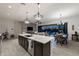 Modern kitchen with an oversized island, pendant lighting, and open access to the outdoor living space at 2046 N Red Clf, Mesa, AZ 85207