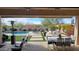 View of the covered patio with a pool and seating area, perfect for outdoor entertaining and relaxation at 2046 N Red Clf, Mesa, AZ 85207