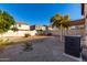 View of backyard with a stone perimeter, partial grass, and block wall fence at 2406 W Tallgrass Trl, Phoenix, AZ 85085