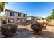 Back exterior of home with patio, block fence, and desert landscaping at 2406 W Tallgrass Trl, Phoenix, AZ 85085