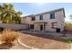 Back exterior of home with patio, block fence, and desert landscaping at 2406 W Tallgrass Trl, Phoenix, AZ 85085