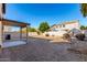 View of backyard with a stone perimeter, partial grass, and block wall fence at 2406 W Tallgrass Trl, Phoenix, AZ 85085