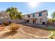 Back exterior of home with patio, block fence, and desert landscaping at 2406 W Tallgrass Trl, Phoenix, AZ 85085