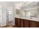 Bathroom with a double sink vanity, a large mirror, and tile flooring at 2406 W Tallgrass Trl, Phoenix, AZ 85085