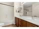 Bathroom with a double sink vanity, a large mirror, and a bathtub with a shower at 2406 W Tallgrass Trl, Phoenix, AZ 85085